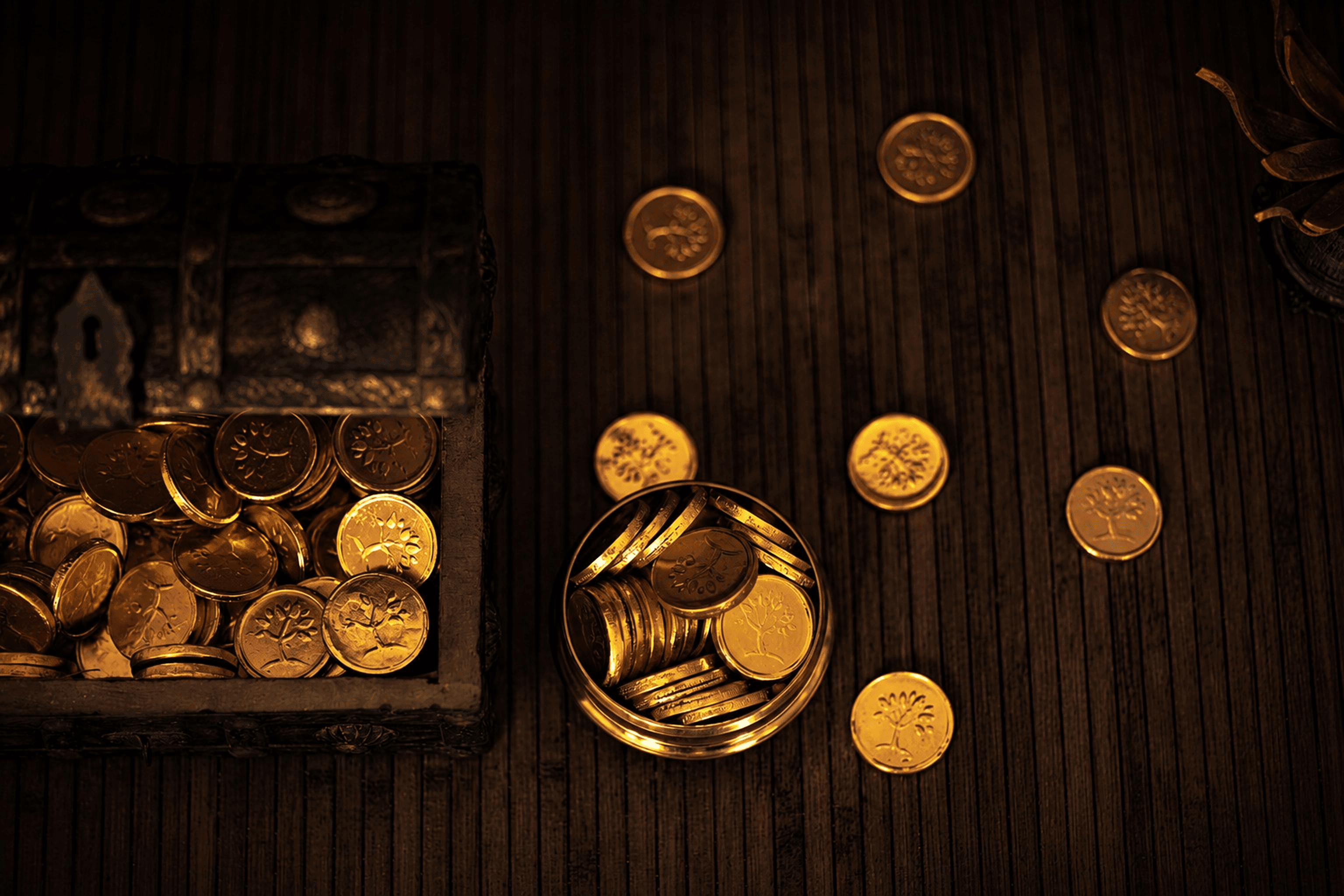 Gold-toned bespoke objects arranged on dark timber